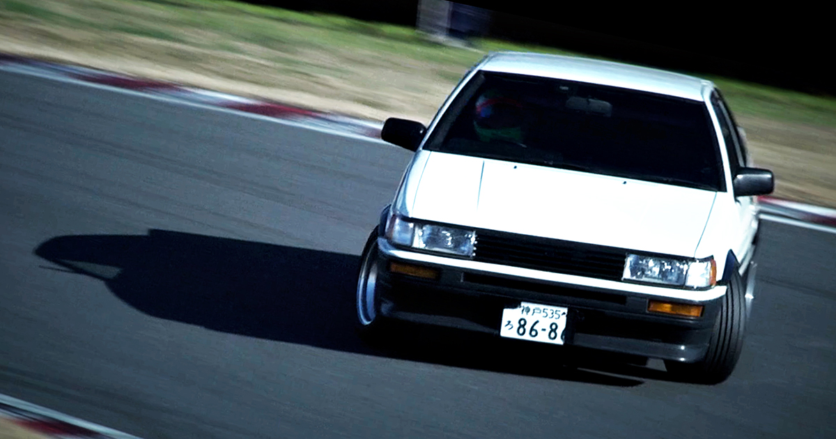 Keiichi Tsuchiya drifting a Toyota AE86 Levin on a racetrack